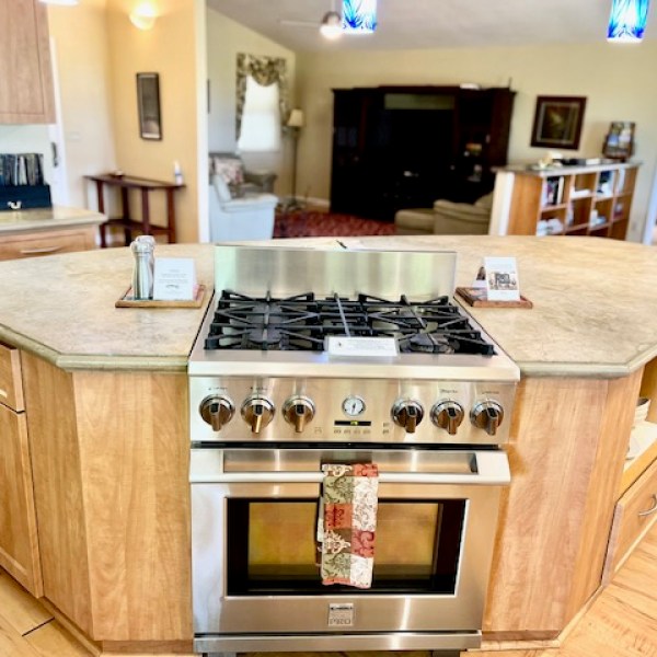 a stove top oven sitting inside of a kitchen