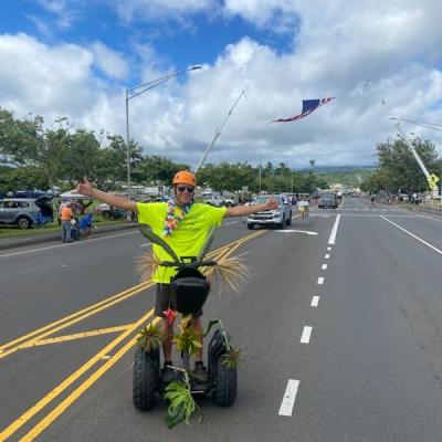 a group of people flying kites in a parking lot