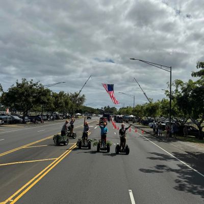 a group of people standing on the side of a road
