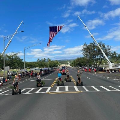 a group of people riding skis on a snowy road